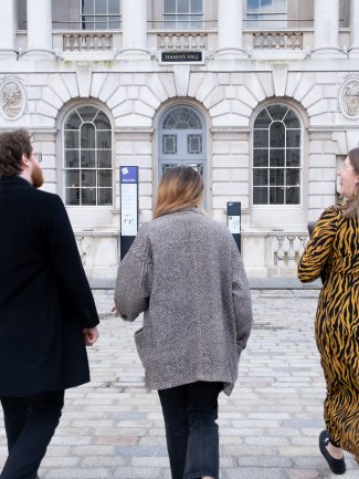 People walking towards a building